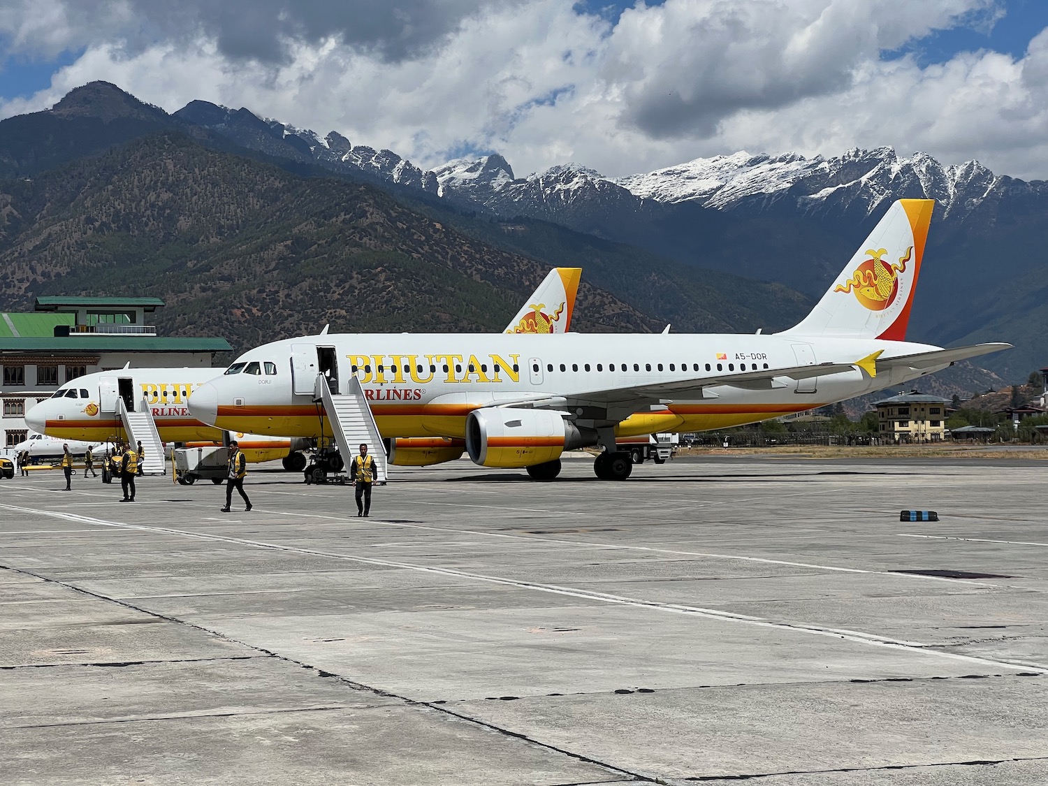 a group of airplanes on a runway