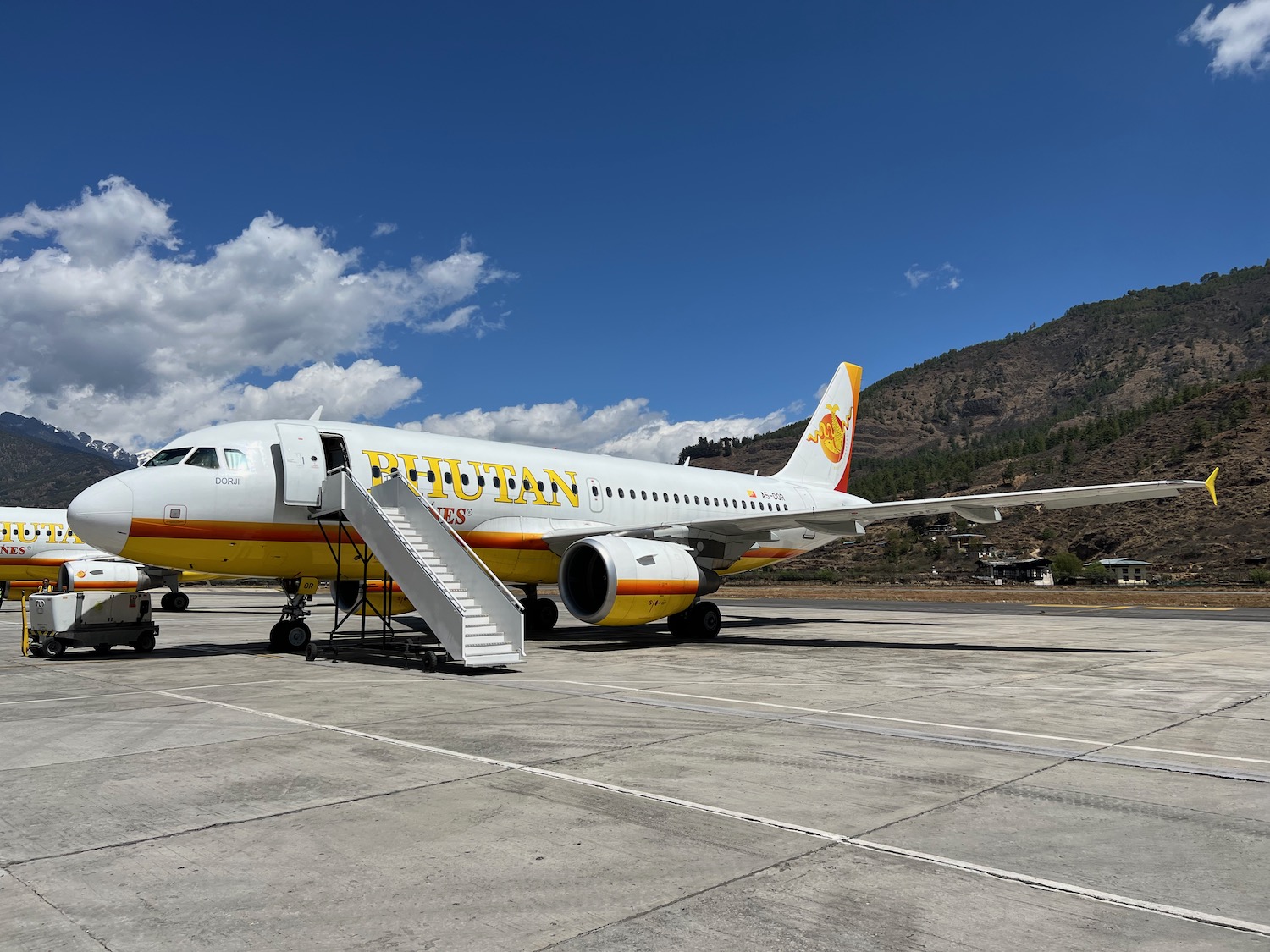 a white airplane with yellow and red text on it