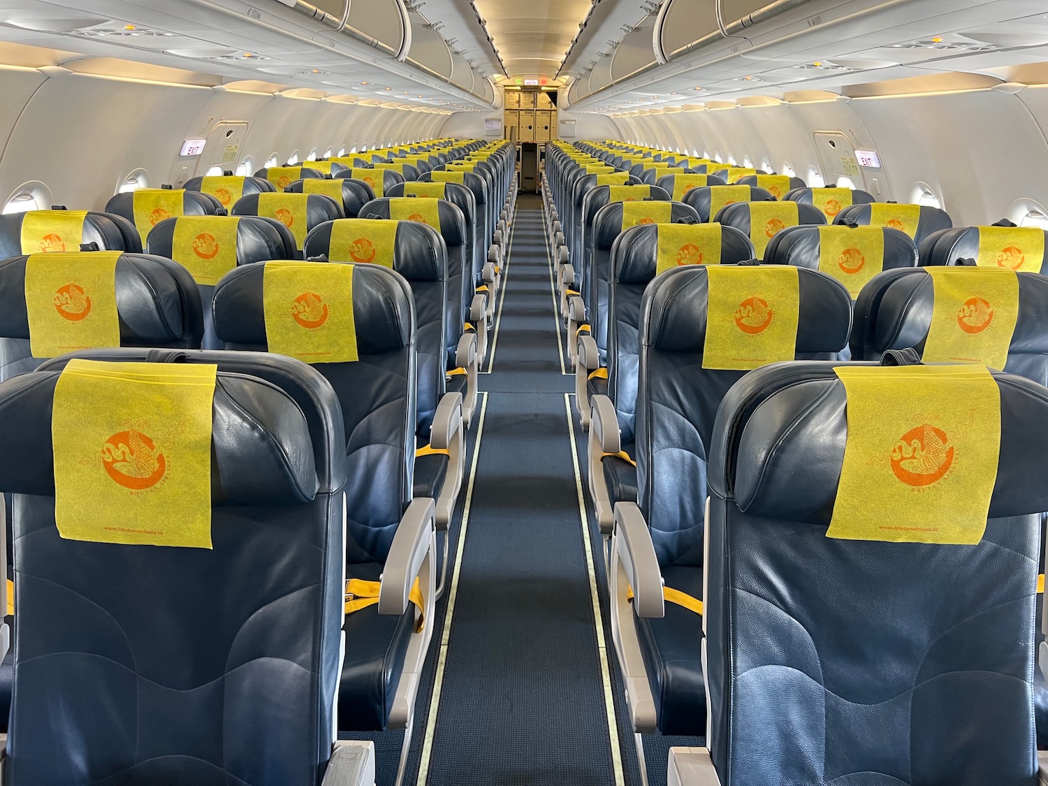 a row of seats with yellow signs on them