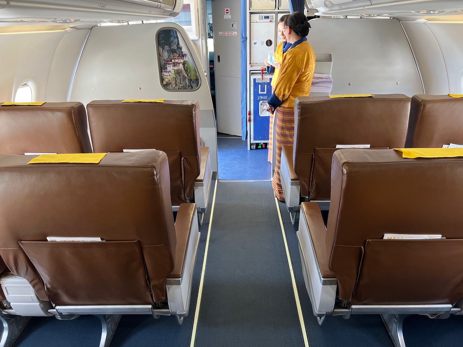 two people standing in an airplane