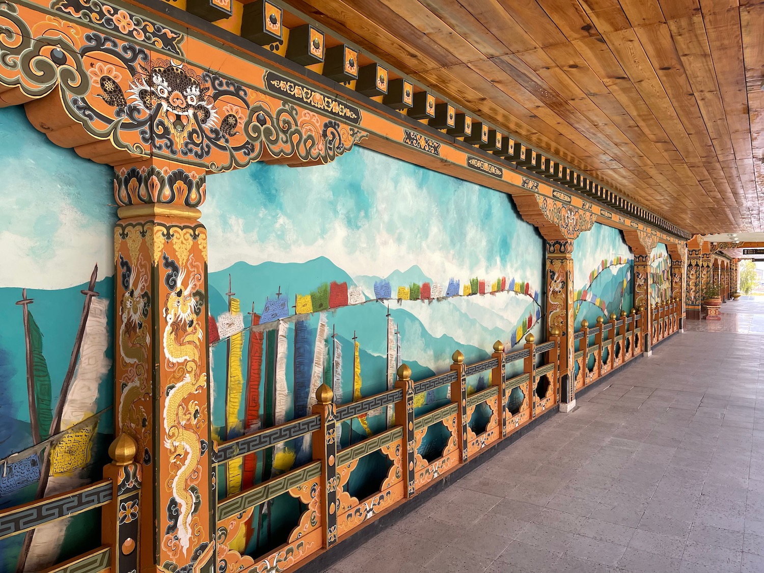 a long corridor with a painting on the wall