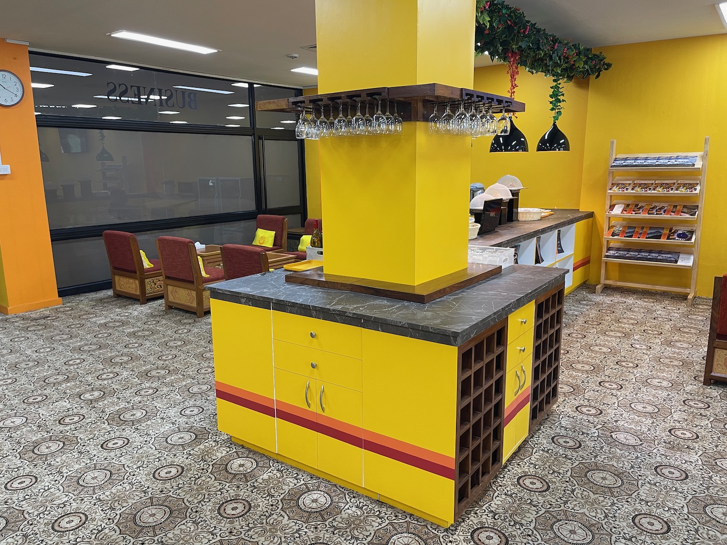 a yellow and brown bar with wine glasses from the top