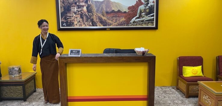 a woman standing at a reception desk