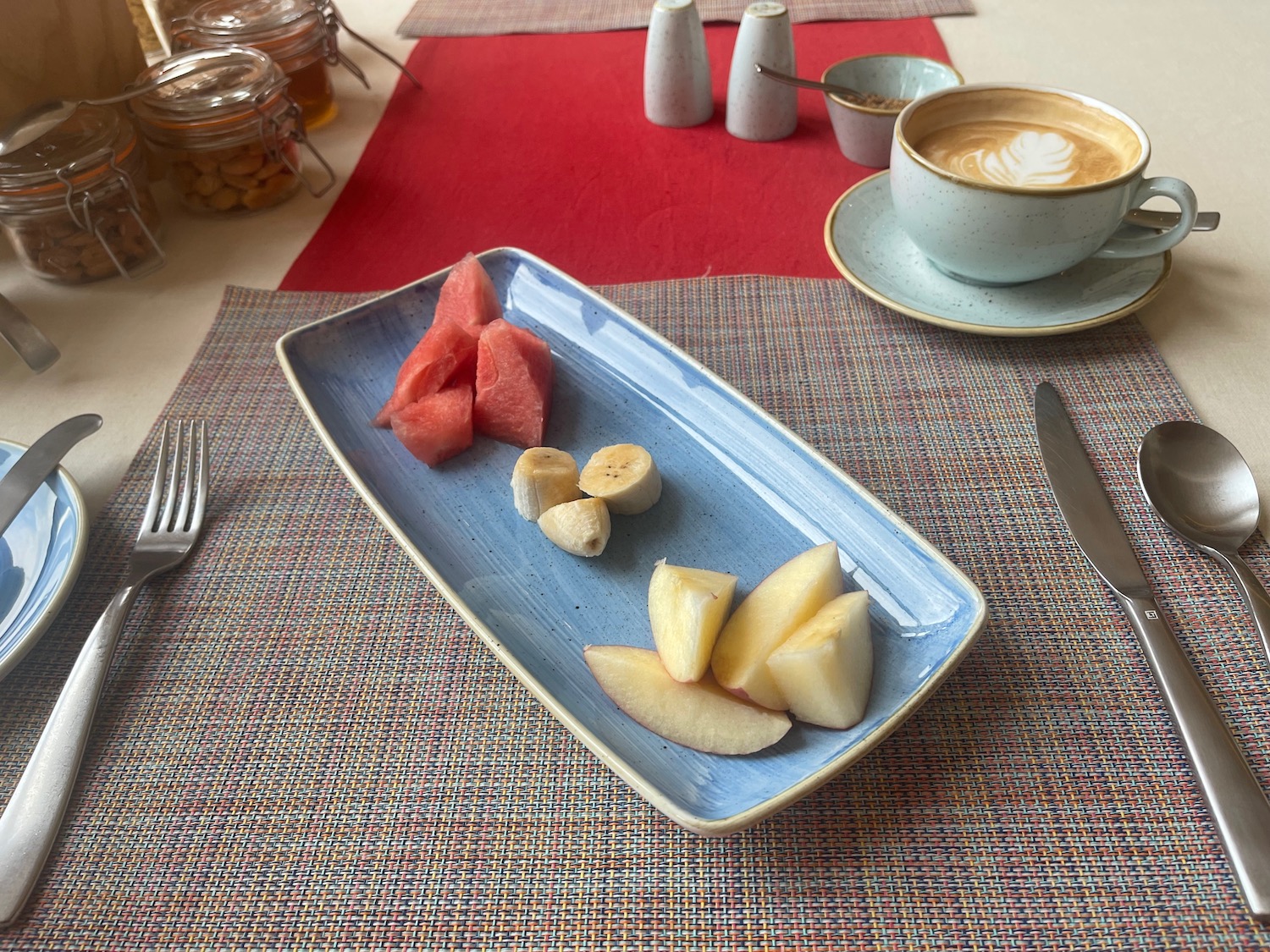 a plate of fruit and a cup of coffee