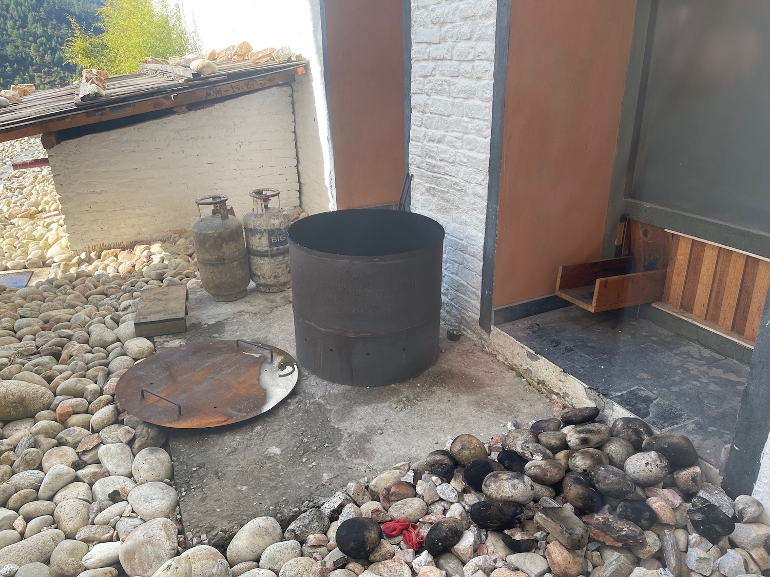 a metal barrel on a patio