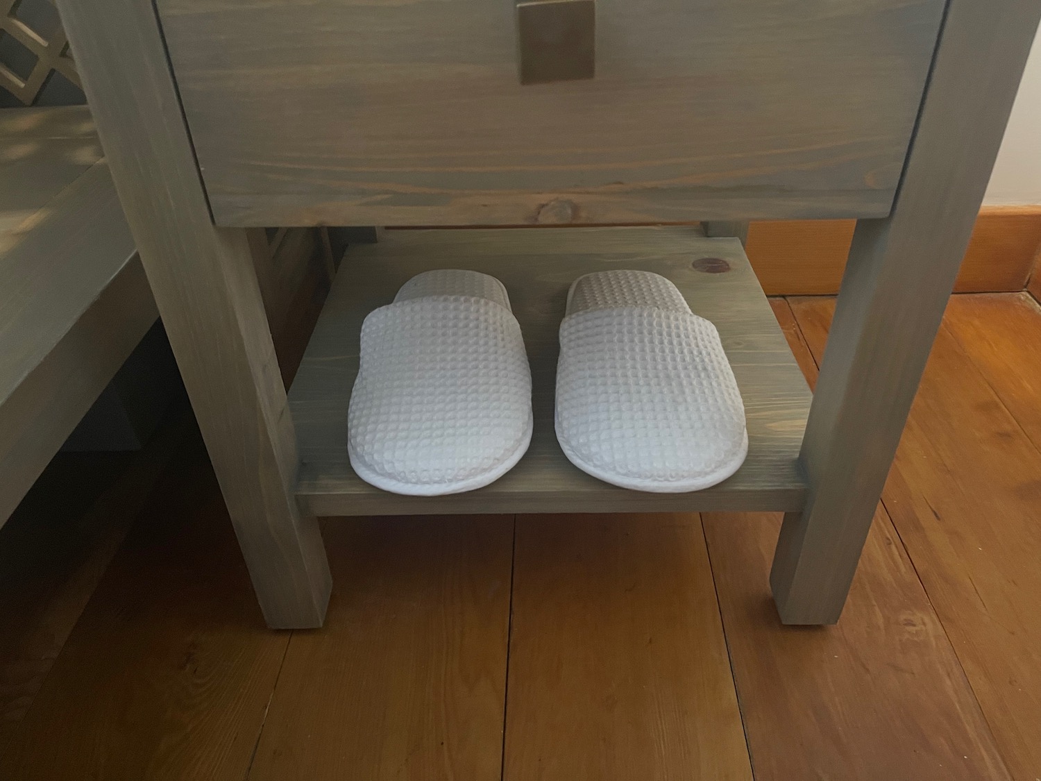 a pair of slippers on a wooden shelf