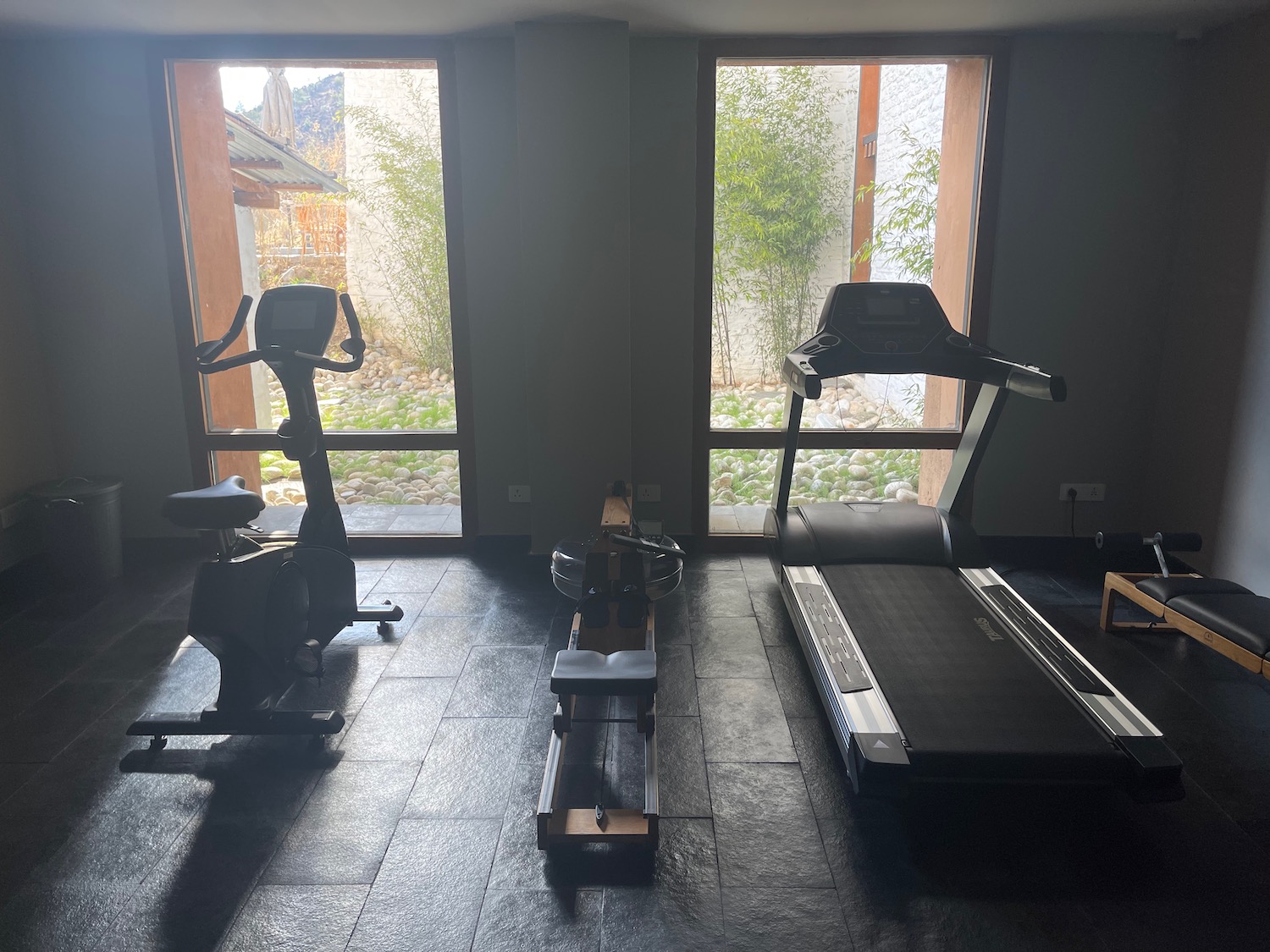 a room with exercise machines and windows