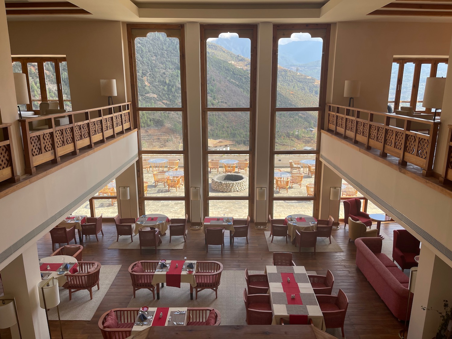 a room with tables and chairs and a large window