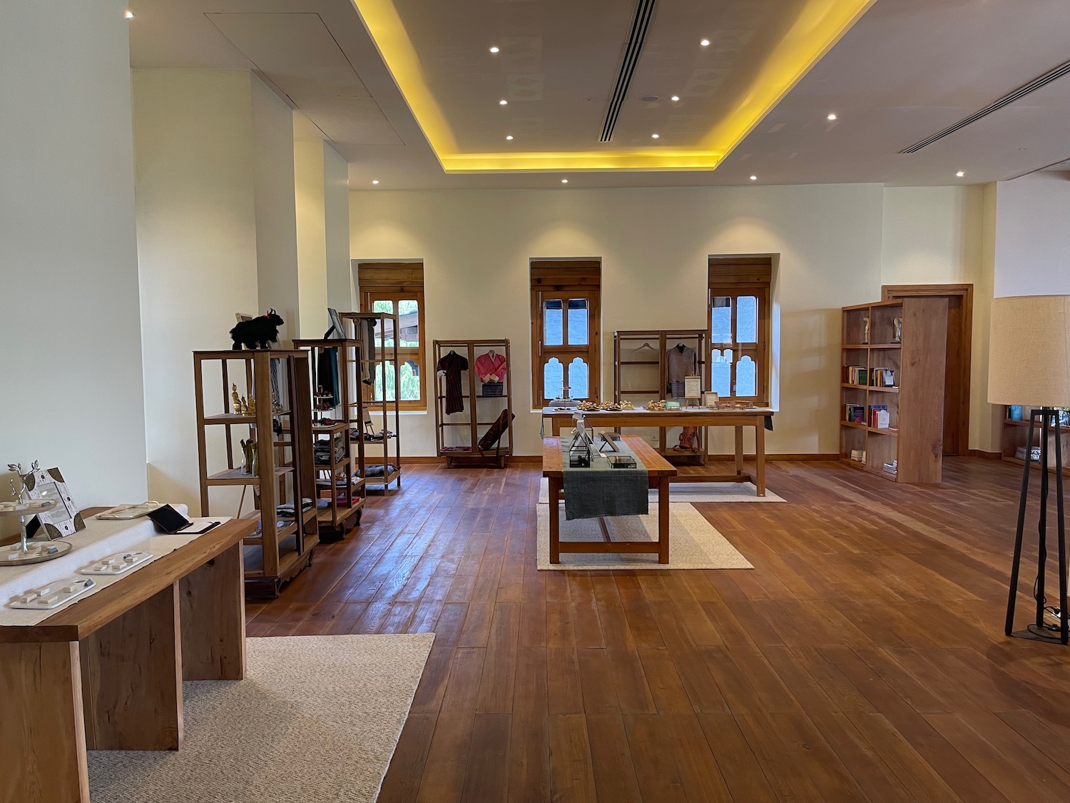 a room with wood floors and a table and shelves