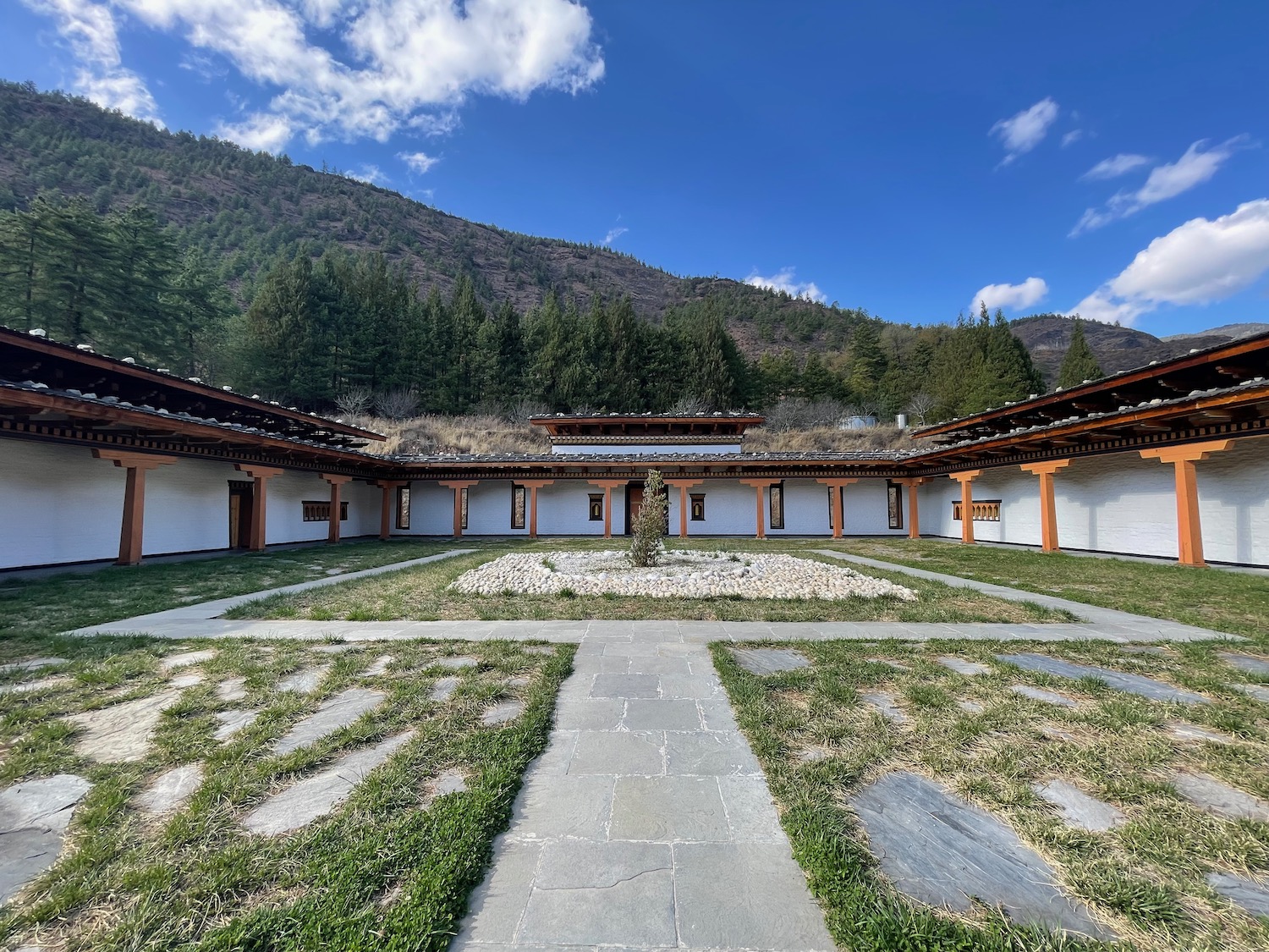 a building with a courtyard and grass