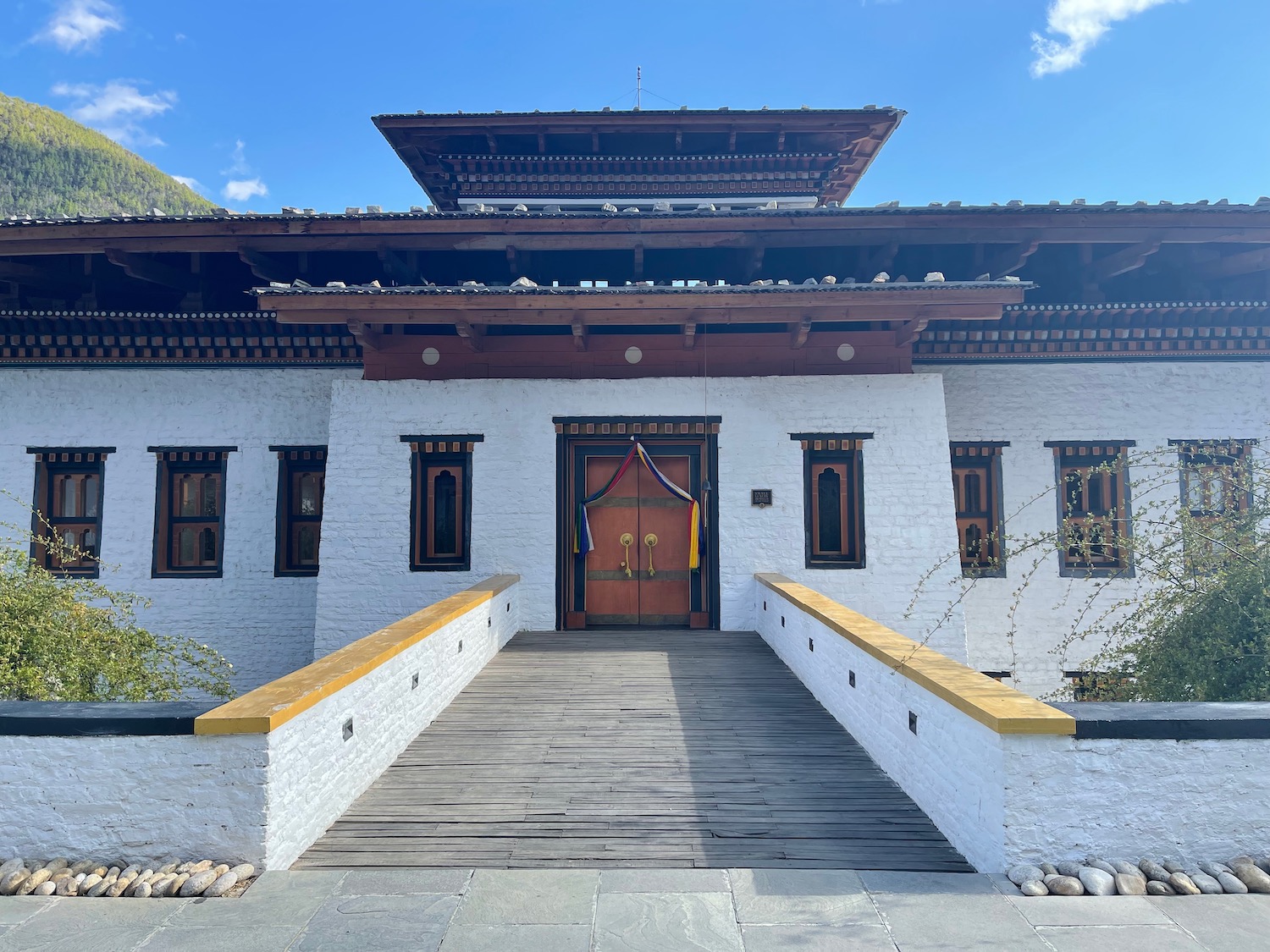 a white building with a wooden walkway