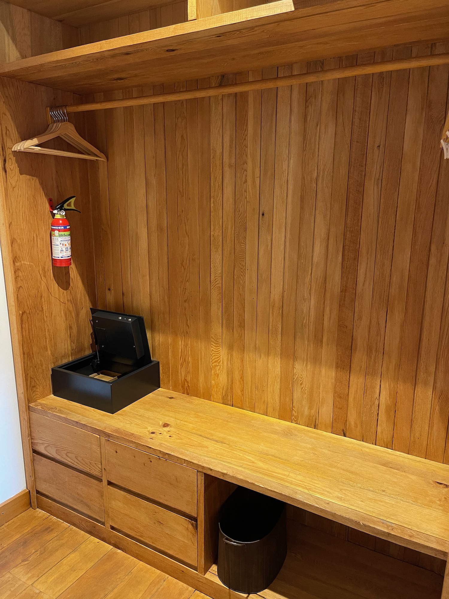 a wooden closet with a fire extinguisher