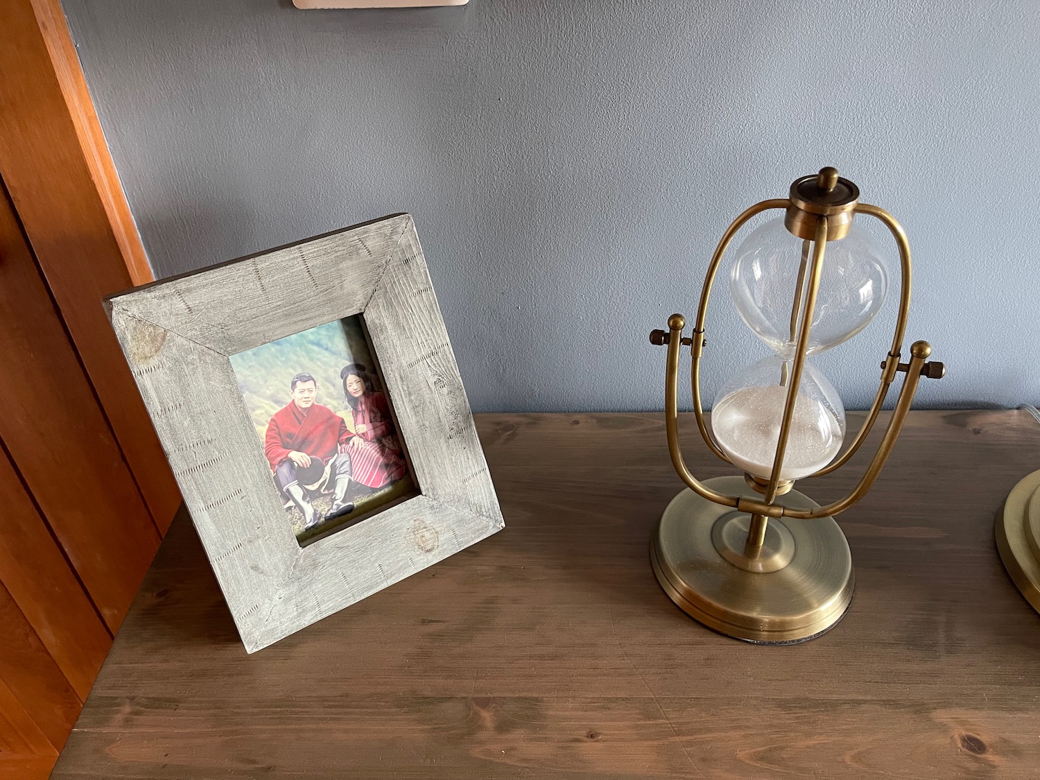 a picture frame and an hourglass on a table