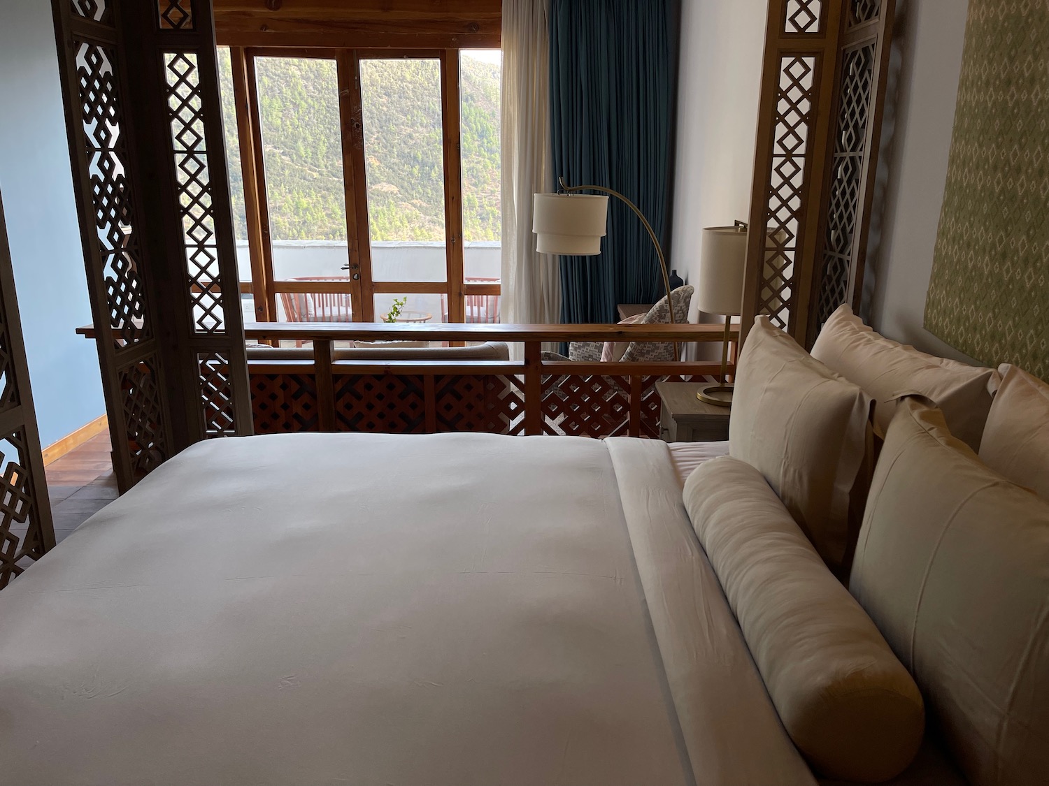 a bed with a window and a view of the mountains