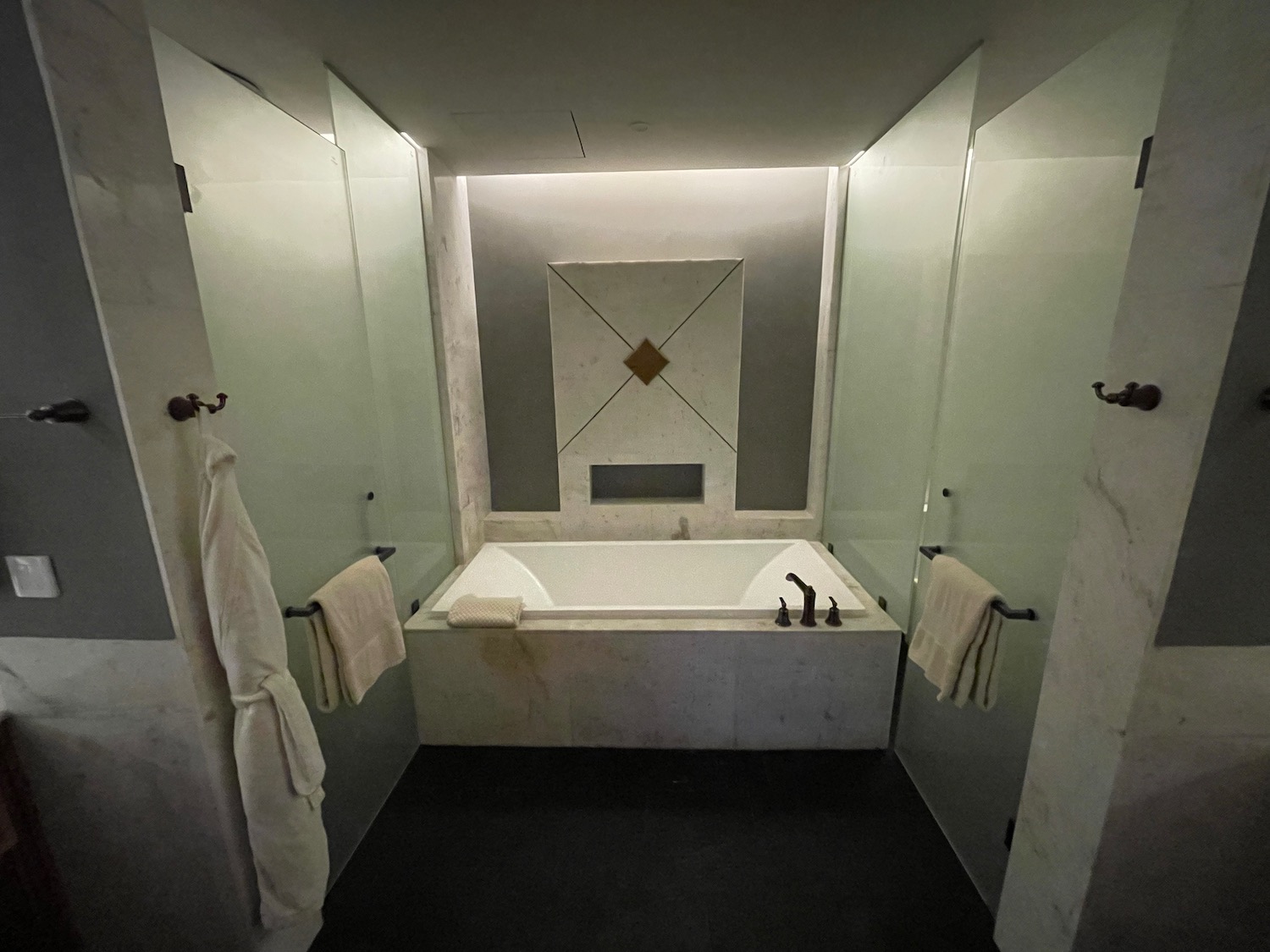 a bathroom with a bathtub and glass doors