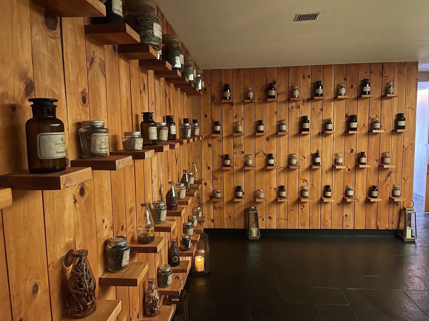 a wall with shelves of bottles and jars