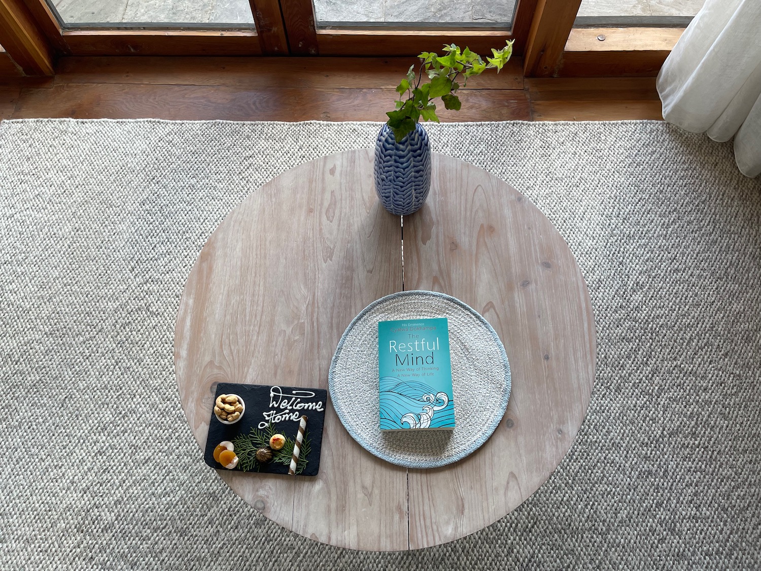 a table with a book and a vase on it