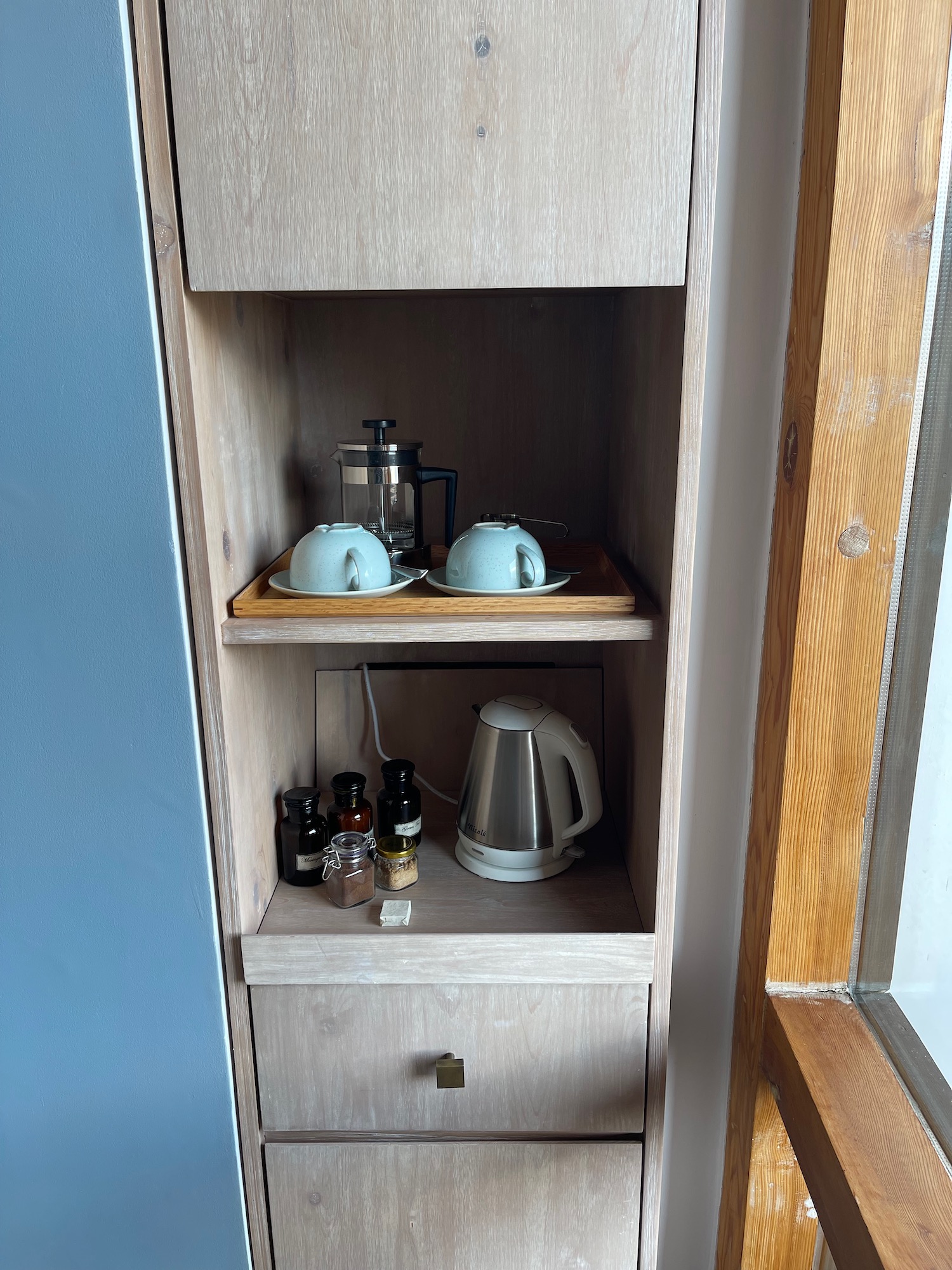 a shelf with teapots and other items