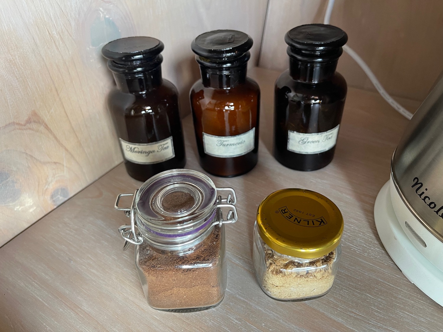 a group of glass jars with brown powder and brown powder