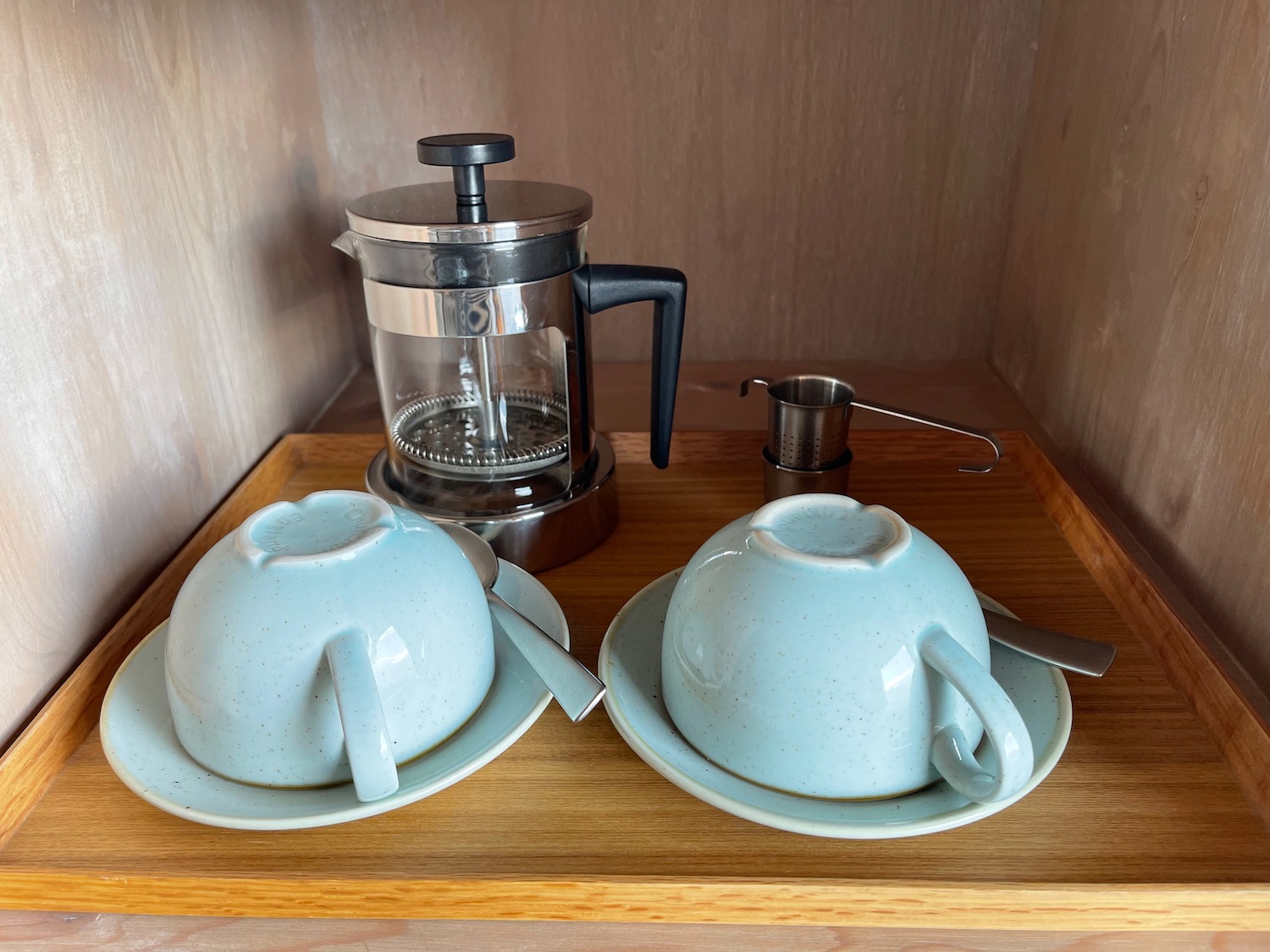 a tray with tea cups and saucers on it