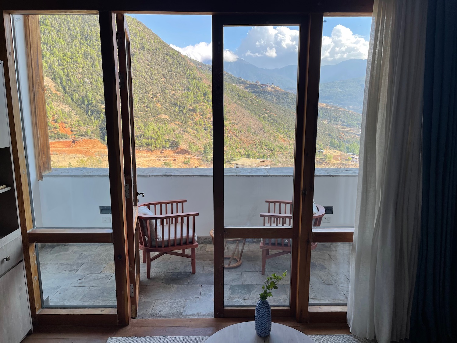 a room with a view of mountains and a table