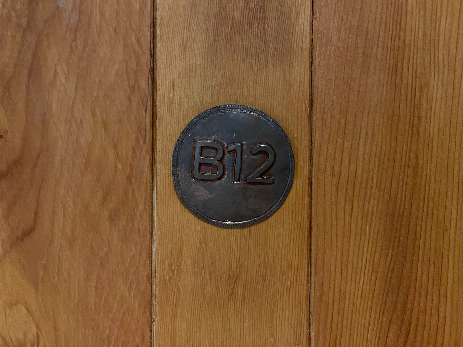 a circular metal object with numbers on a wood surface