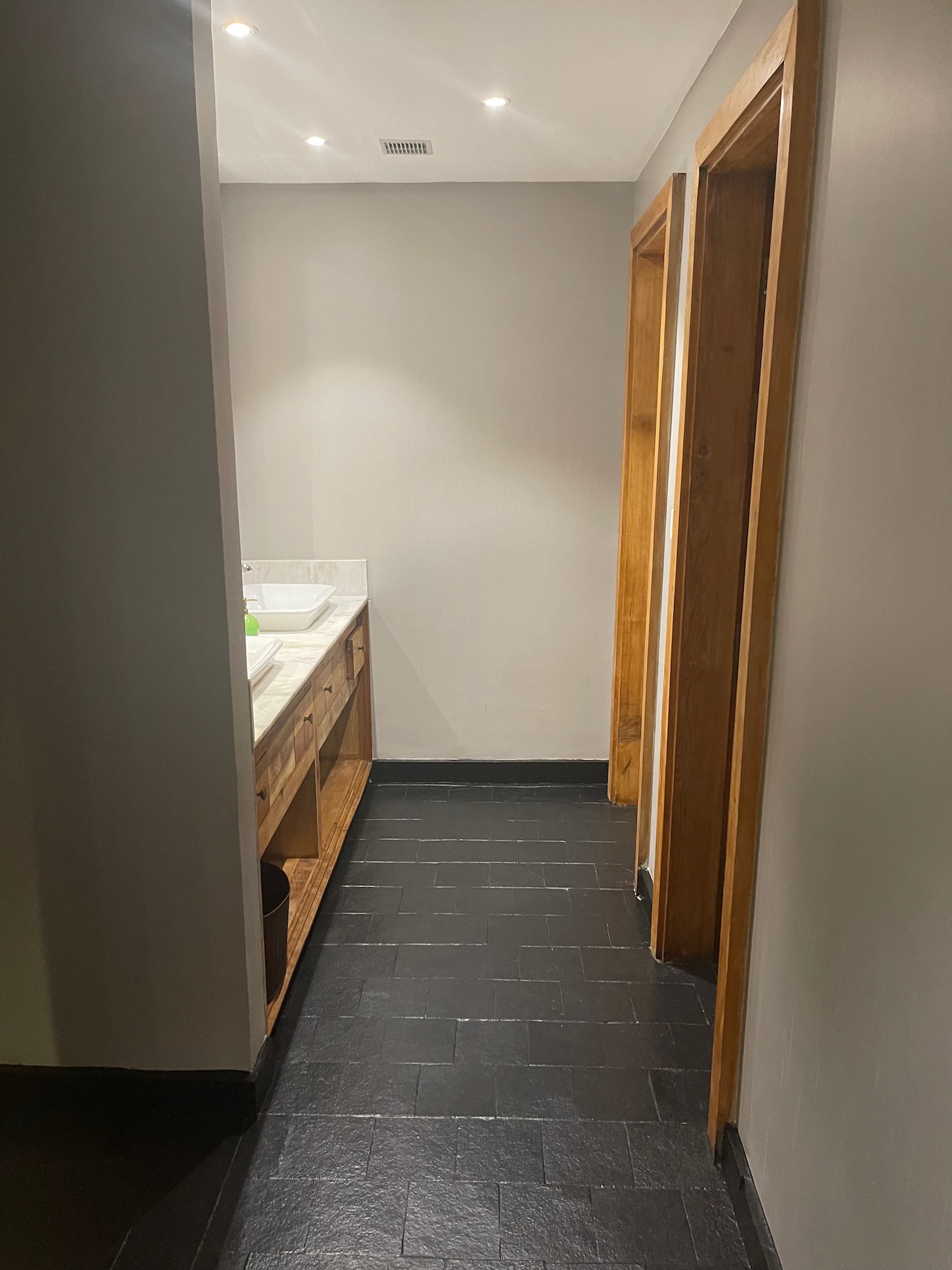 a bathroom with a sink and a black tile floor