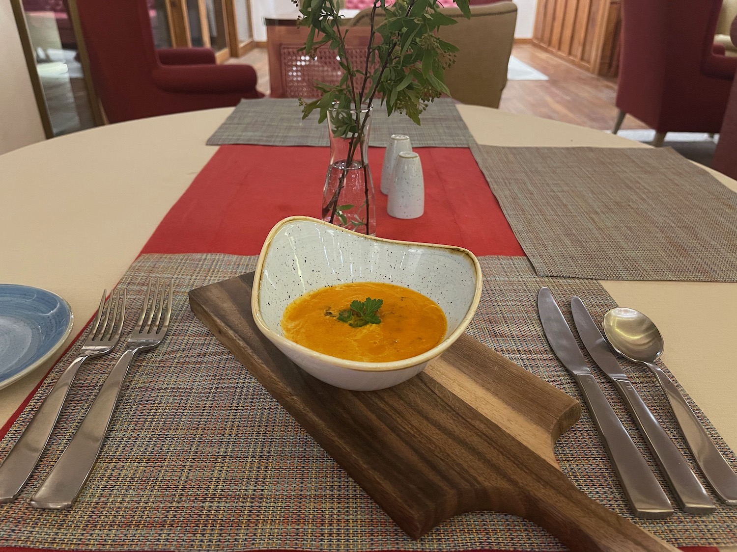 a bowl of soup on a cutting board