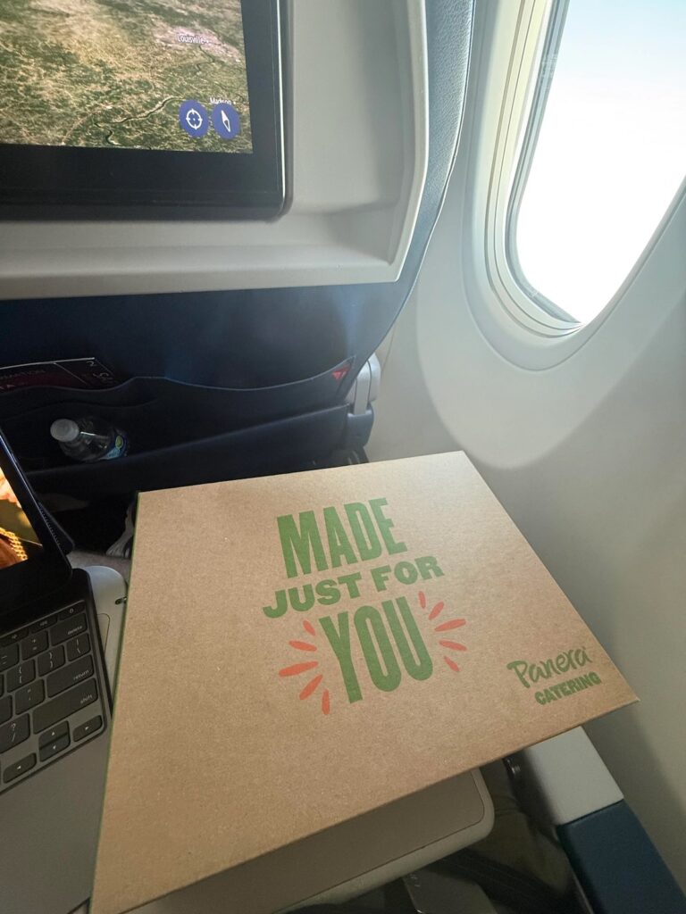 a cardboard box on a table next to a laptop