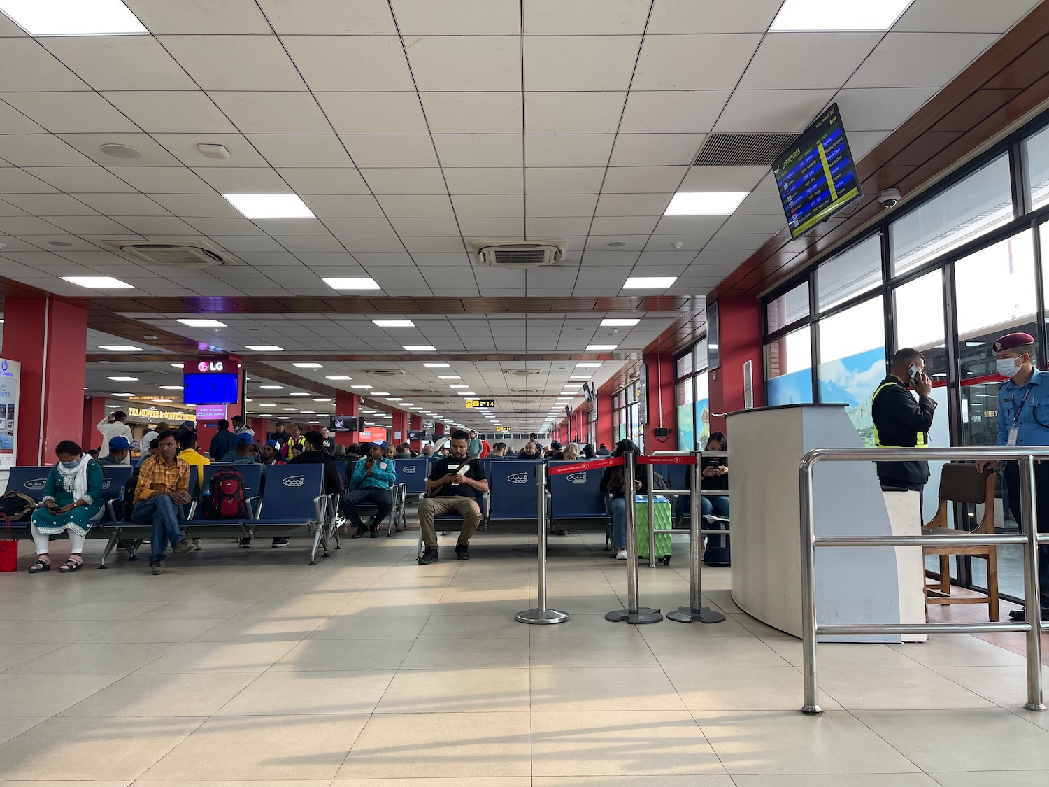 a group of people sitting in chairs in a terminal