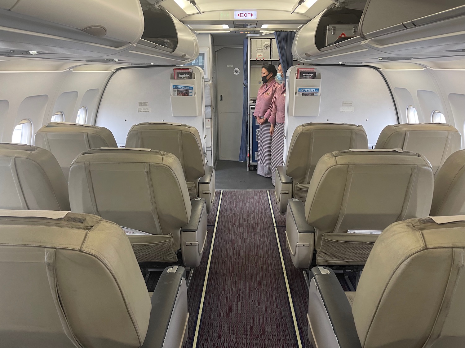 a couple of women standing in an airplane