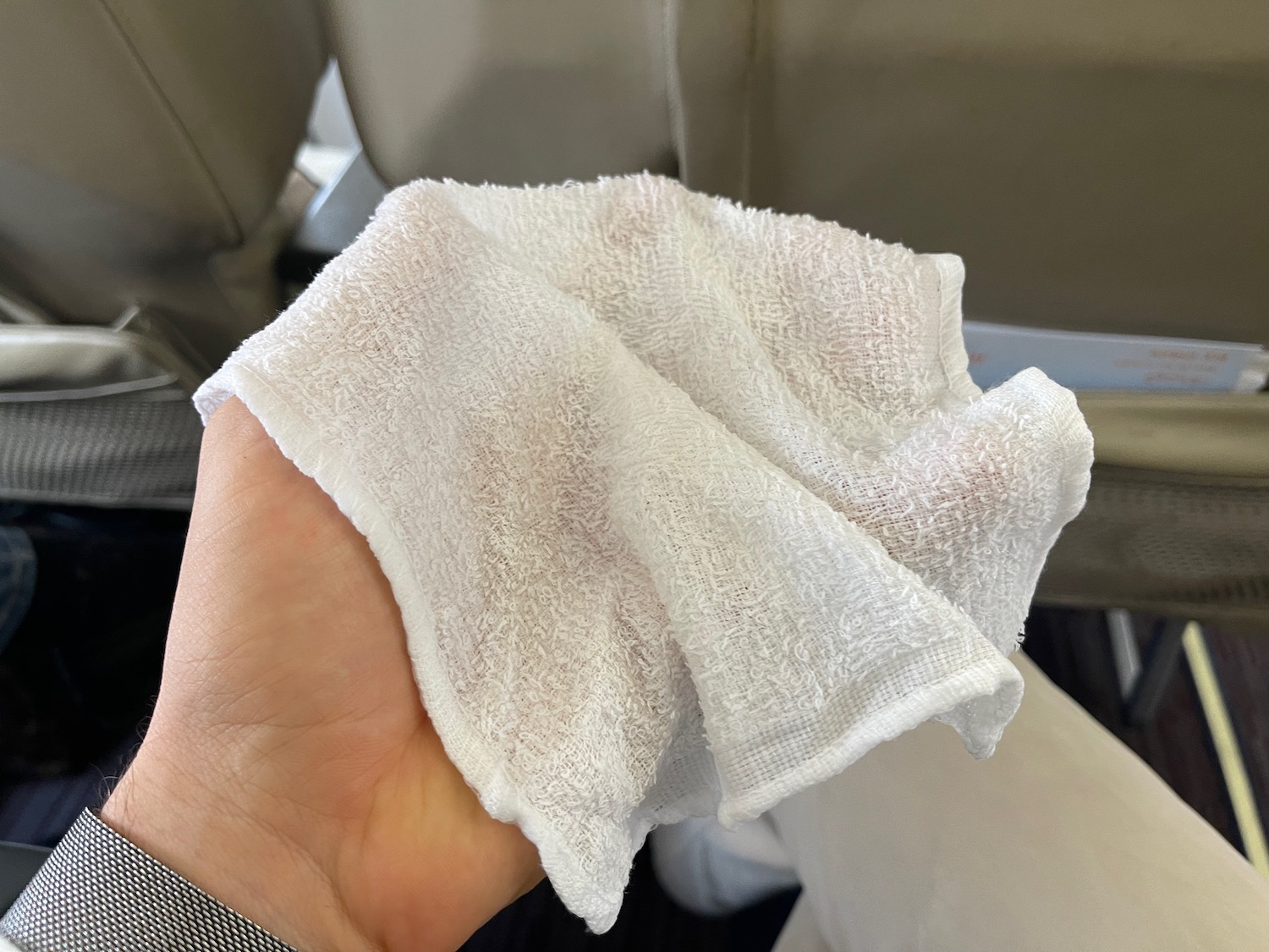 a hand holding a white towel