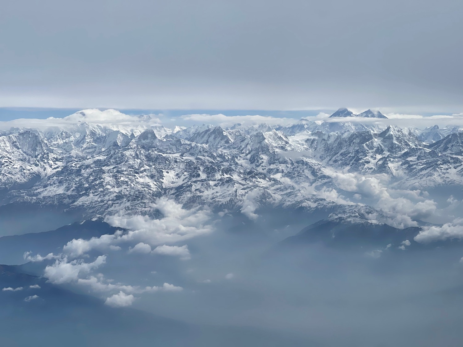 a snowy mountain tops and clouds