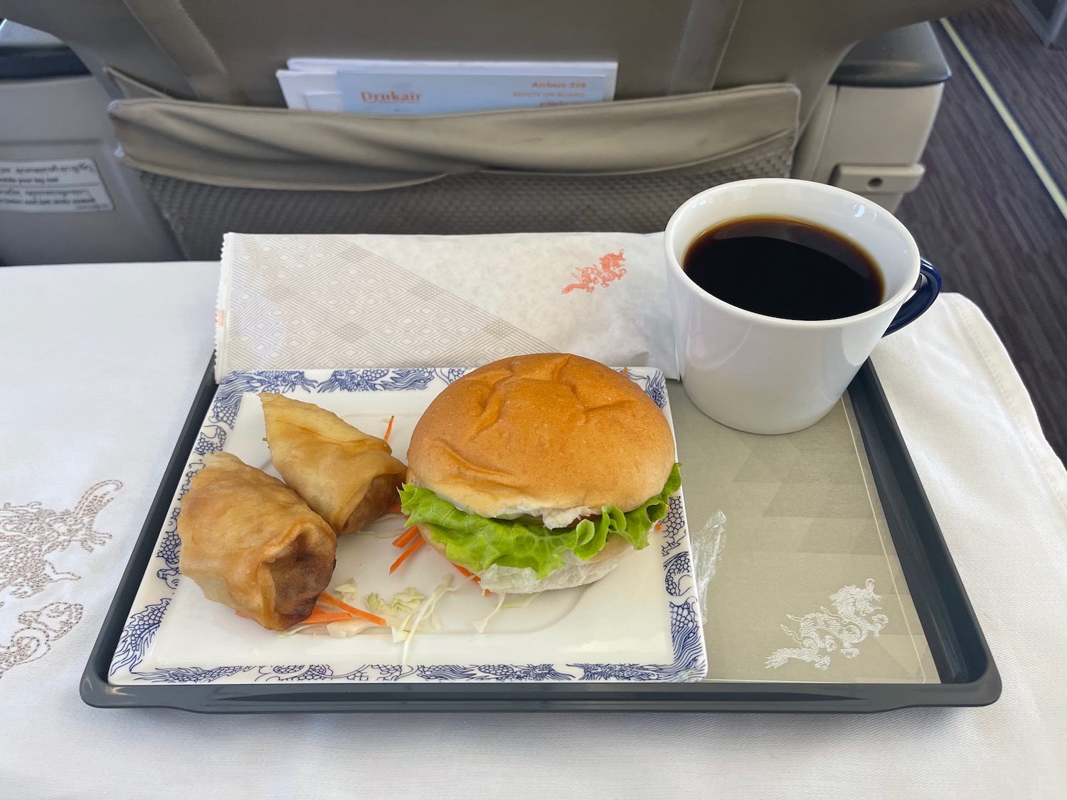 a tray with food and a cup of coffee on it