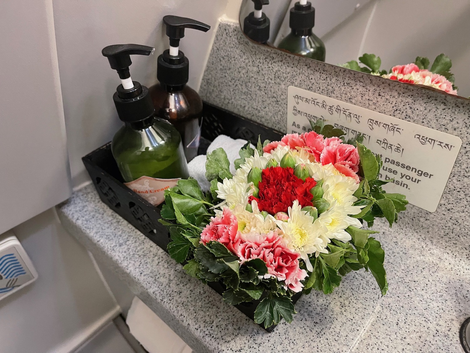 a group of flowers and bottles on a counter