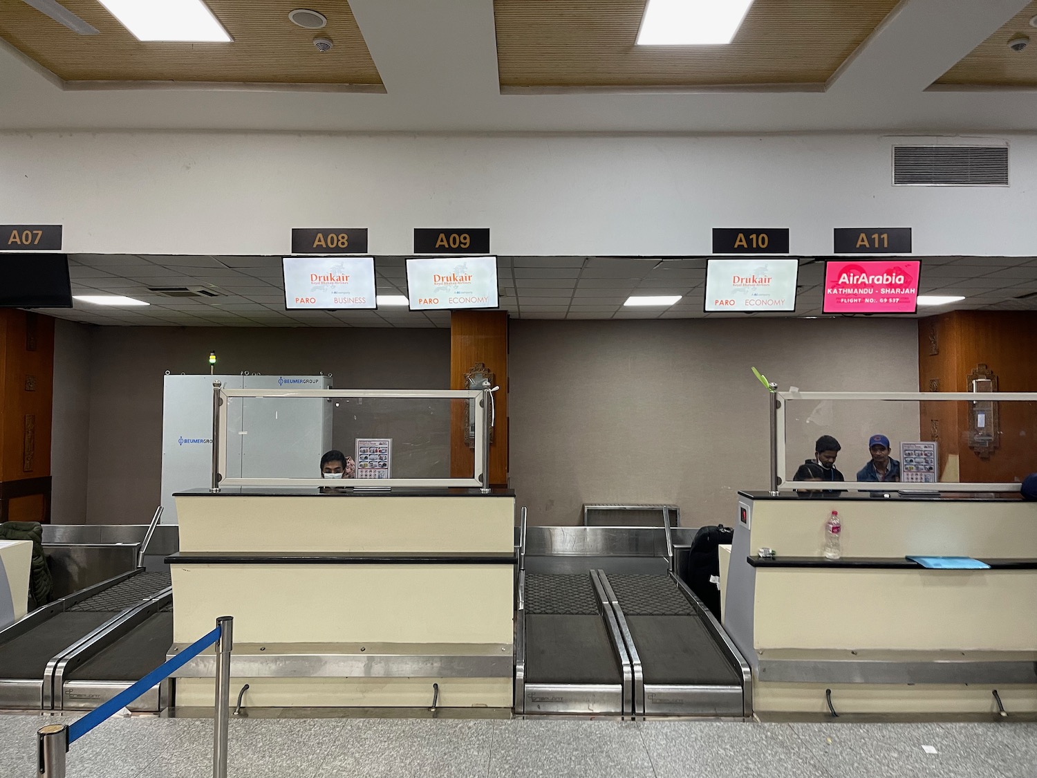 people standing in front of a conveyor belt