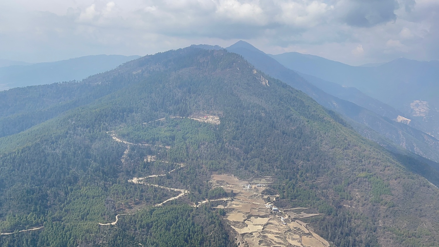 a mountain with trees and a road