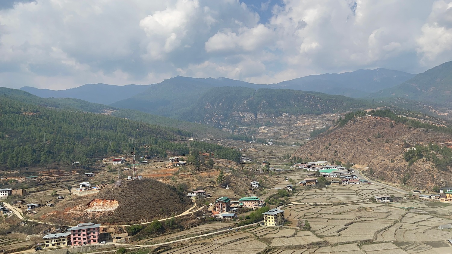 a landscape with a village and mountains