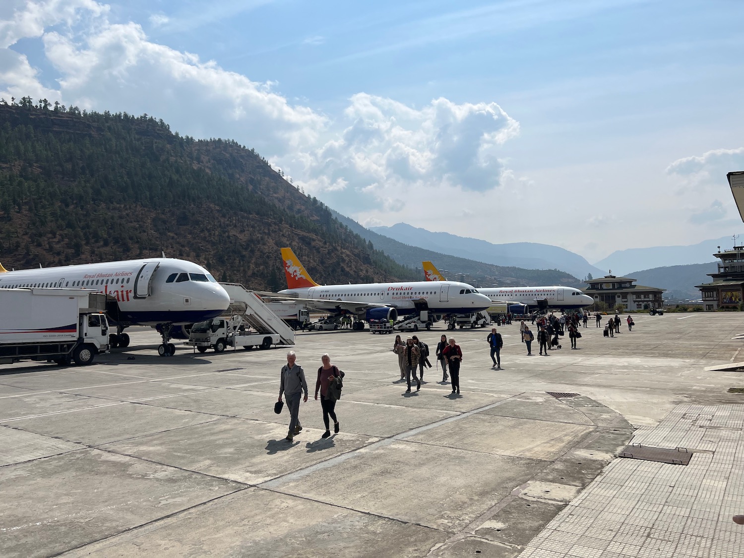 a group of people walking around airplanes