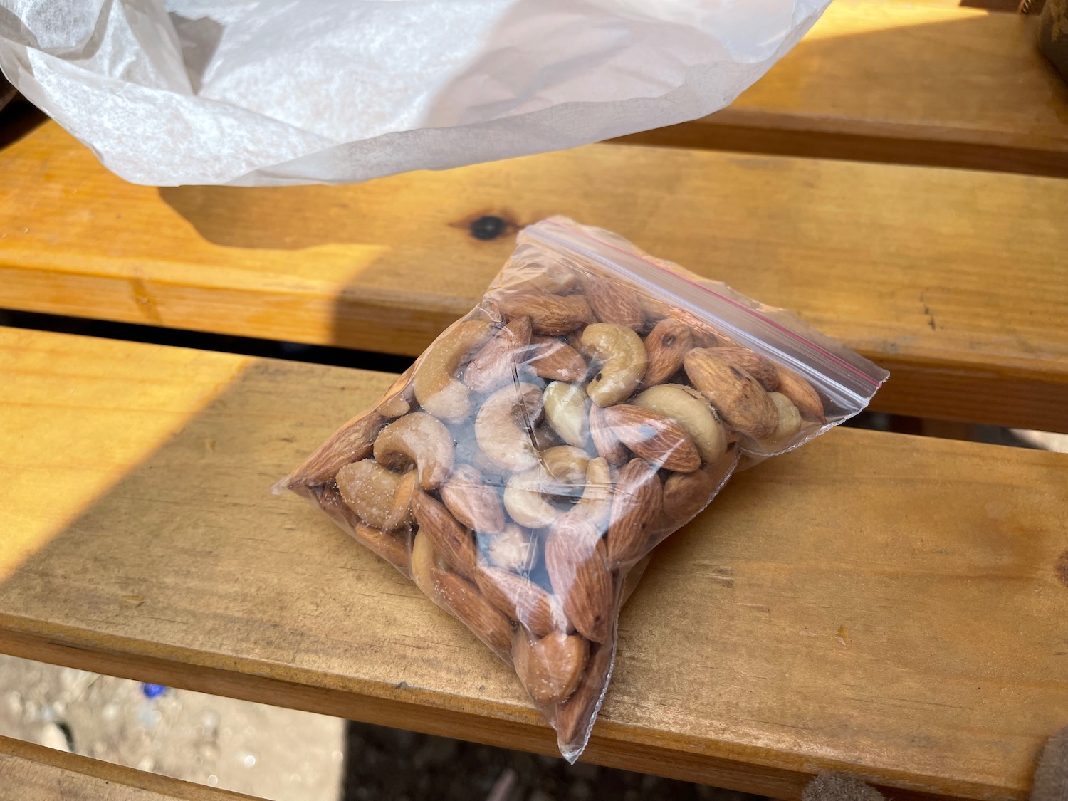 a bag of nuts on a bench