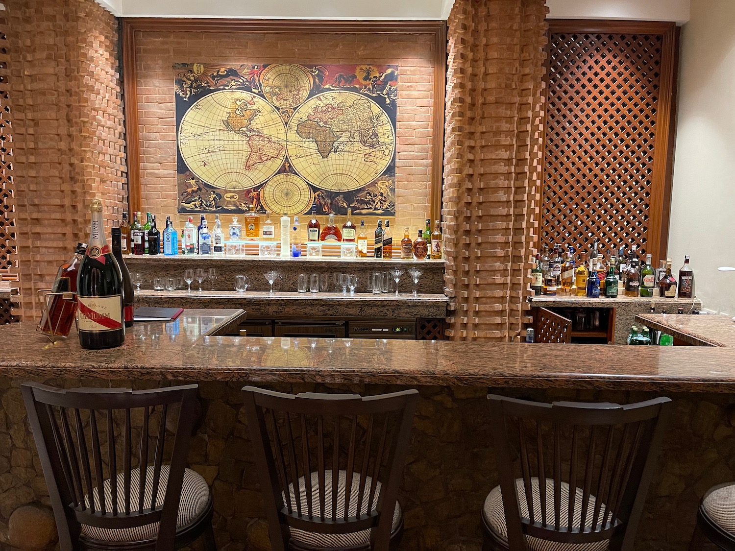 a bar with bottles of alcohol and a map on the wall