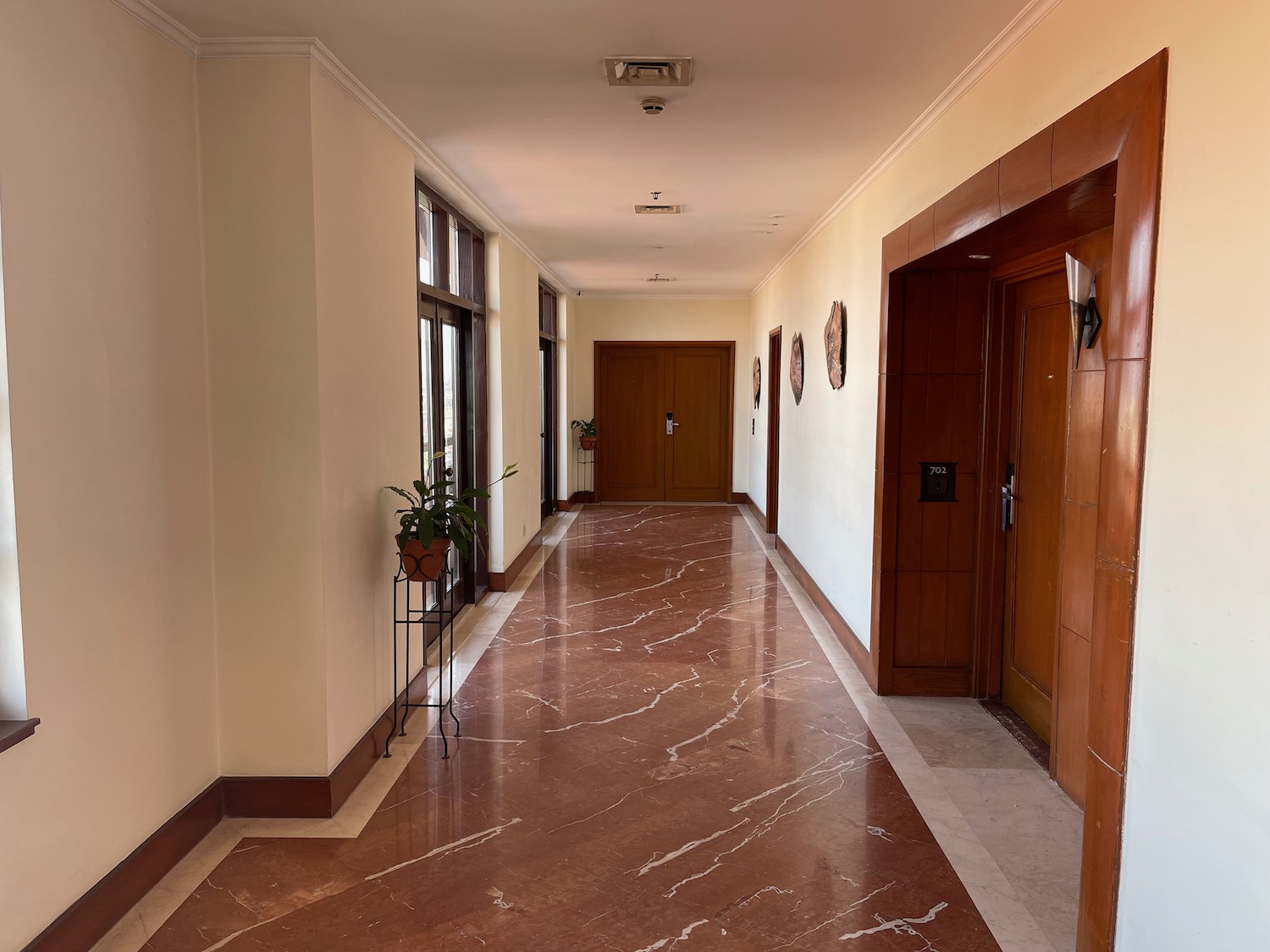 a hallway with a marble floor and doors