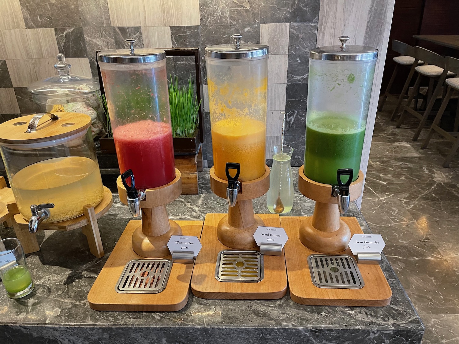 a group of drinks dispensers on a marble counter