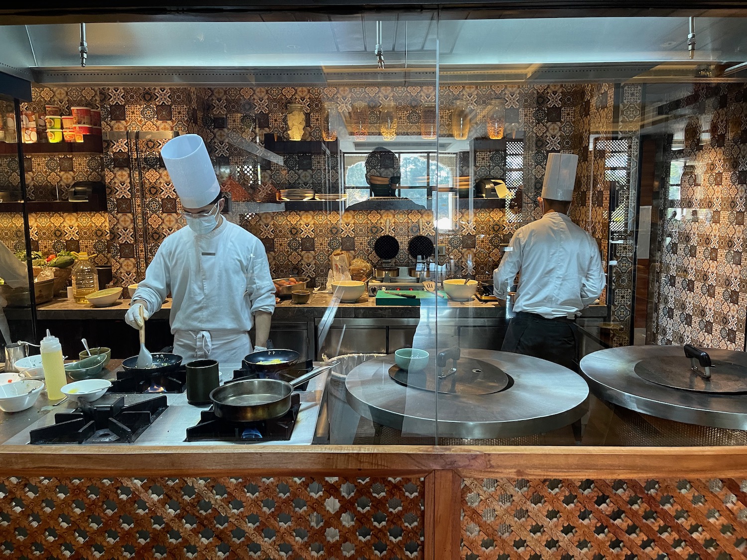 a group of chefs cooking in a kitchen