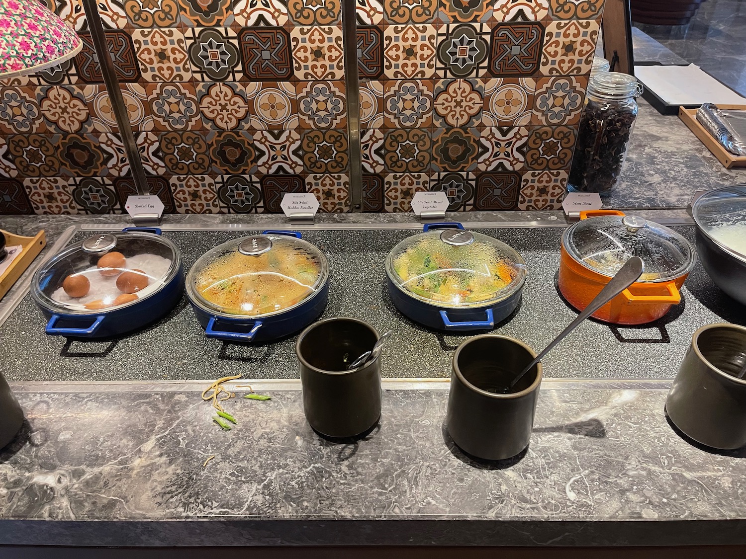 a group of pots with food on a counter