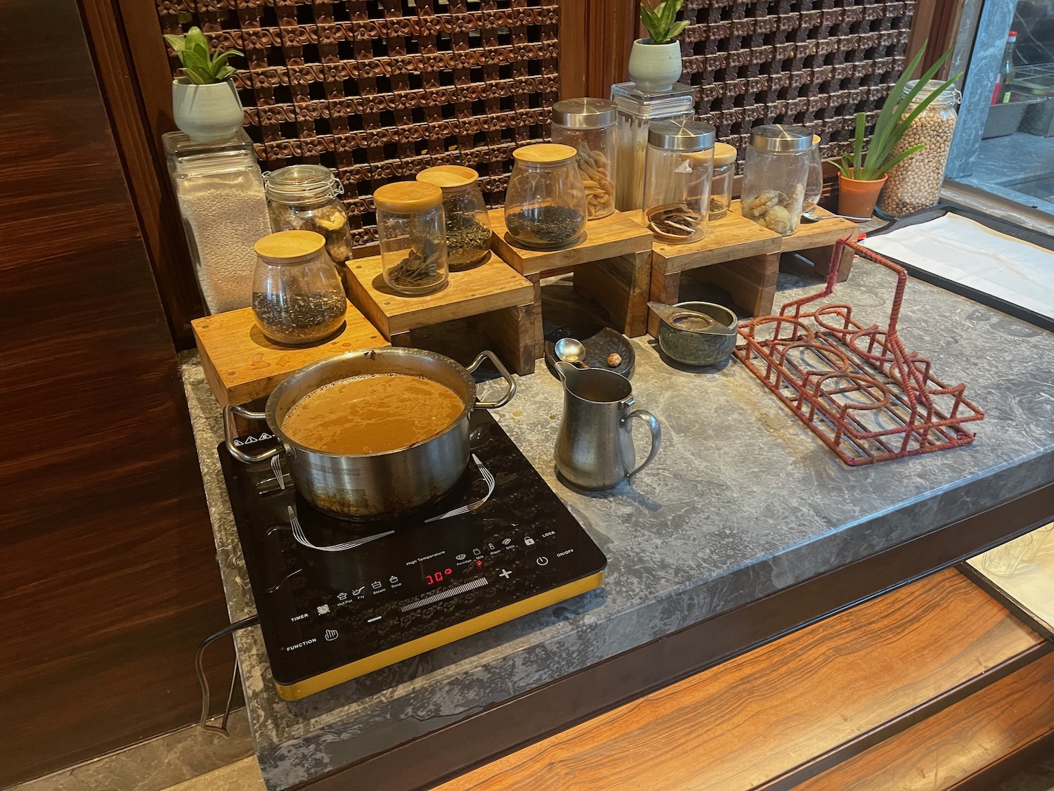 a kitchen counter with pots and jars