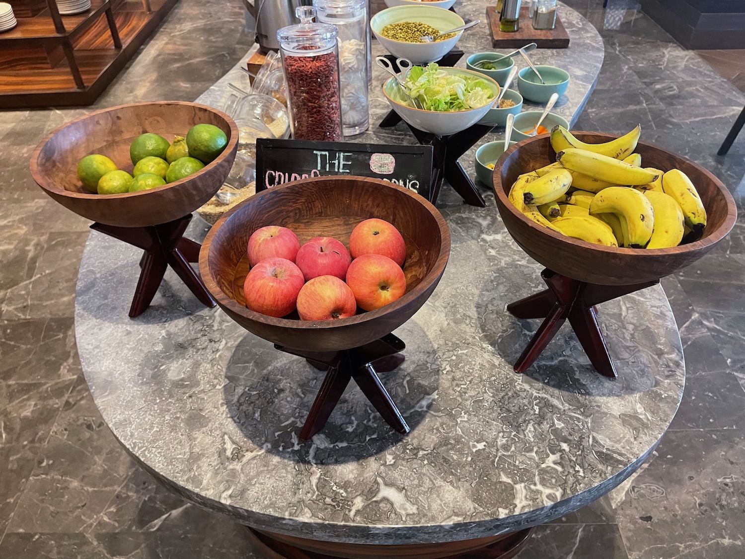 a table with bowls of fruit and vegetables