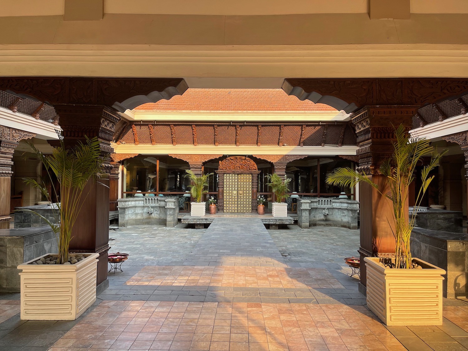 a building with a brick walkway and plants