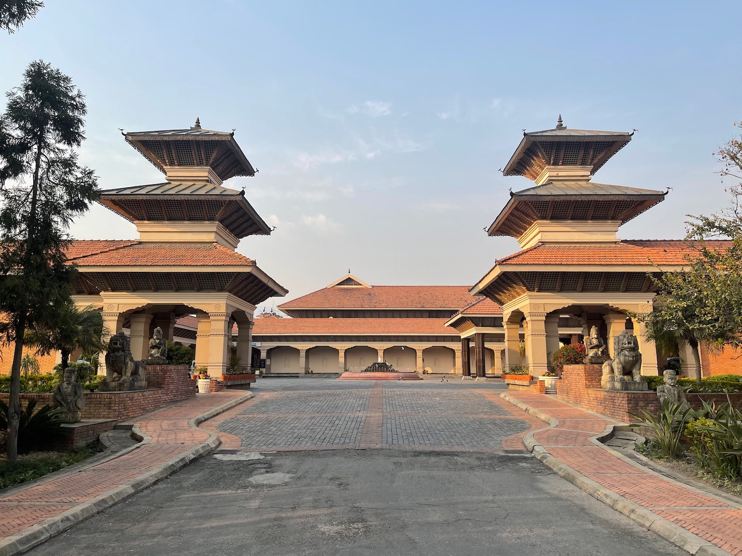 a large building with a brick driveway