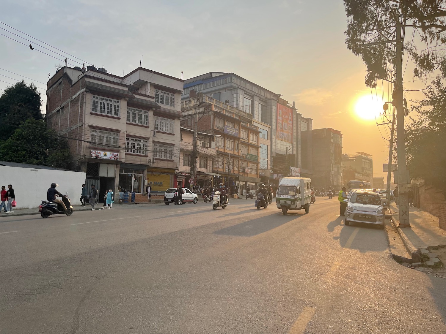 a street with cars and people on it